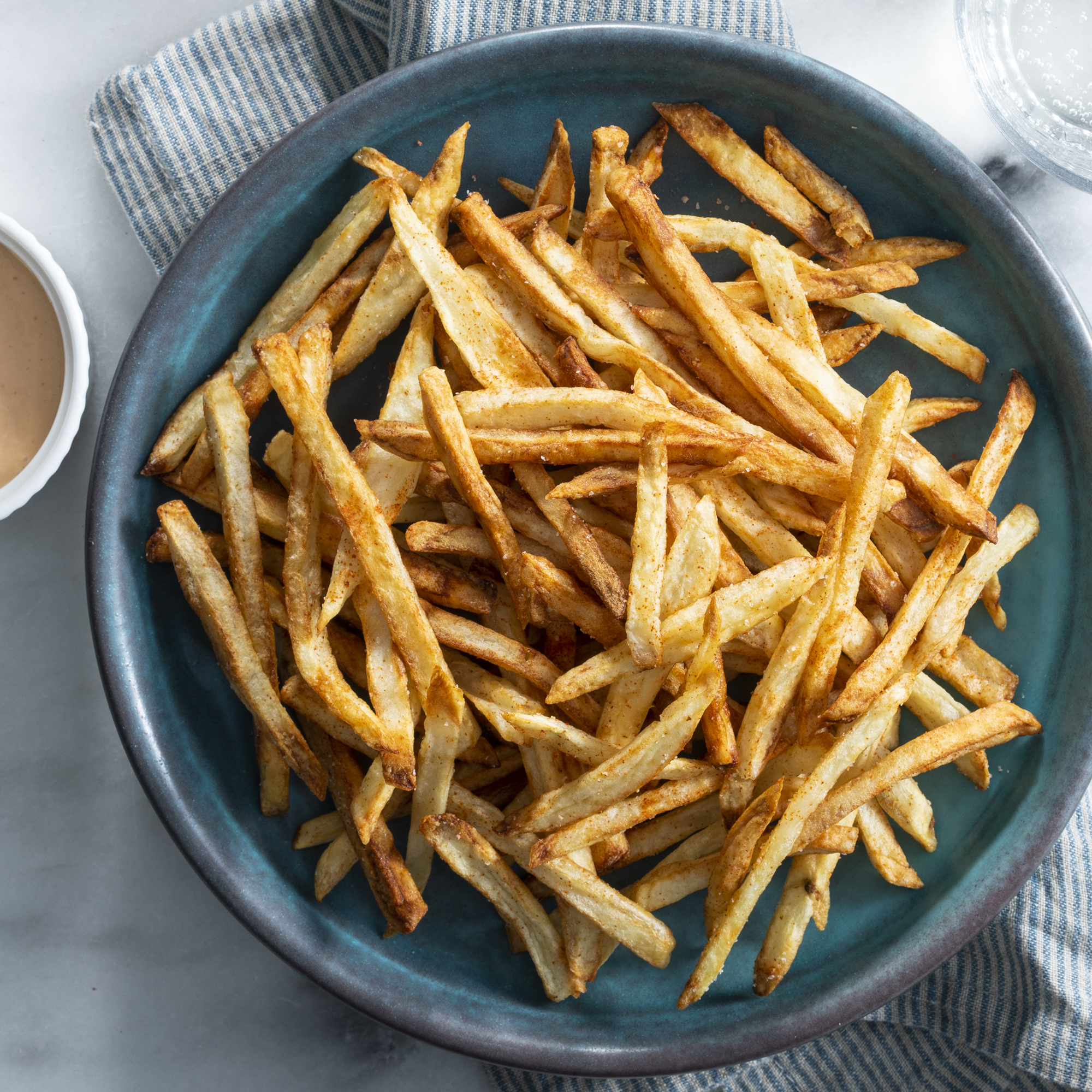 Photo of French fries in blue bowl.